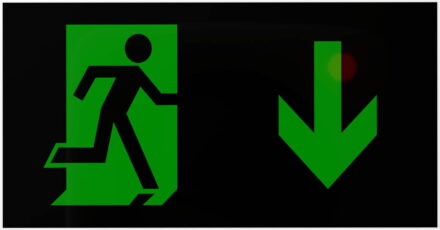 X-ES Cinema Exit Legend Arrow Down black background with green symbols